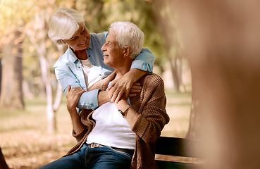 Image showing Love, senior couple and hug in park on bench, bonding and romantic together outdoor. Romance, mature man and elderly woman embrace, loving or happy for relationship, marriage and retirement in nature