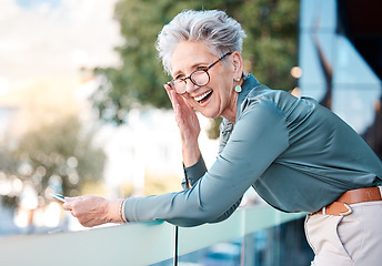 Image showing Phone, funny and city with a business woman outdoor standing on a the balcony of her office at work. Comic, mobile and communication with a senior female manager or CEO outside in an urban town