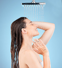 Image showing Woman, shower and water mockup for skincare health, showering for clean skin and natural wellness. Healthy beauty model, happy face and advertising healthcare or hygiene on a studio blue background