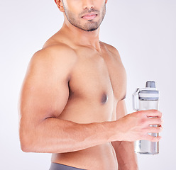 Image showing Muscle, body and man with water bottle for healthcare exercise or personal trainer. Wellness model, training or fitness strength motivation and workout with strong hands in grey studio background