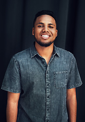 Image showing Happy portrait, pride and black man in studio for happiness, posing and fashion style against dark black background. Smile, denim and face of an African model with stylish clothes on dark background