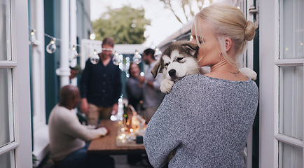 Image showing Love, dog hug and woman at a house party, happy celebration and friends in a backyard during a holiday. Social content, lunch and girl with a husky puppy at a home dinner in a garden with people