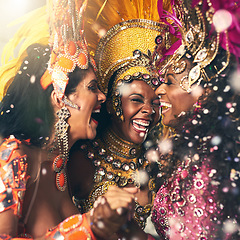Image showing Women, laughing or samba carnival dancers in Brazilian in celebration event, street night party or city performance. Dancing festival, feathers or fashion costume for smile, happy or bonding friends
