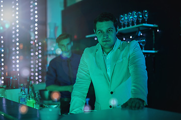 Image showing Club, drink and portrait of a bartender working at a party, happy hour and night club event. Lens flare, alcohol server and barman at a dark nightclub for drinks, work and entertainment lifestyle