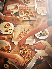 Image showing Top view of pizza, hands and people with food, drink and celebration, party or social gathering event at dining table. Group of friends, fast food and pizzas in lunch, dinner and restaurant cafeteria