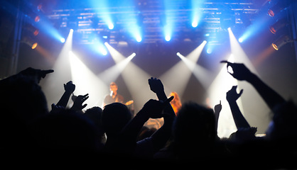 Image showing Concert, dance and audience at a band performance, techno festival and event with people on a stage in the dark. Night club, dancing and crowd with freedom, energy and rock at a music festival