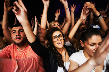 Image showing Crowd, concert and people in stadium for music, rock or event with community, energy or hands in air. Group, fans and party for music festival, dance or friends together in arena in night in New York