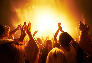 Image showing Music, concert and crowd with light, clapping for live performance, rock event and band on stage at night. People, audience and music festival, audio and sound with energy at show with musical artist