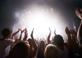 Image showing Concert, live music and people dancing at an event, party or nightclub with energy, freedom and fun. Band, musician or dj entertainment playing at music festival or rave at indoor venue with a crowd.