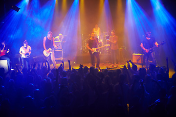 Image showing Music, live concert and band playing a song for audience at a rock, punk or folk festival. Disco light, night event and stage with performance artist play at a music festival with people cheering