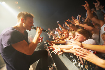 Image showing Man, singing music and concert with crowd, energy and crazy fan, rock performance and festival with audience. Singer, audio sound and music festival with live show, people and artist sing to women