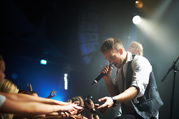 Image showing Musician, singer and performance at concert with music and audience for music festival, live entertainment with band at event. Artist, festival in Las Vegas and man with microphone, singing with fans