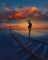 Image showing Woman at beauty sunset on salty lake
