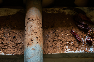 Image showing Grinding cacao beans with chili peppers