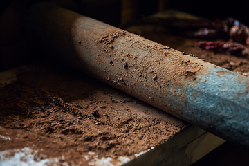 Image showing Grinding cacao beans with chili peppers