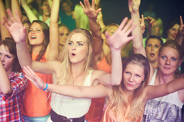 Image showing Women, hands up and dancing at music festival, live band performance and techno rave party in nightclub, concert and disco. Friends, crowd and audience on dance floor in show, freedom or energy event