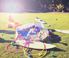 Image showing Man, backyard and passed out on grass, drinking and party in summer at with butt open in kids pool. Drunk person, sleeping and lawn with toys, sunshine or hangover on vacation, holiday or celebration