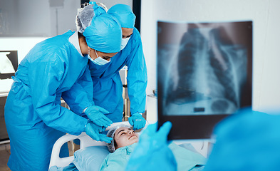 Image showing Patient, surgeon and team in operating room, hospital and healthcare emergency, surgery or medical clinic. Doctors, nursing staff or workers in face mask, blue scrubs and working in operation theatre