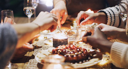 Image showing Dinner, celebration and friends with sparkles at party for Christmas, new years eve and festive gathering. Friendship, happiness and hands of people lighting sparklers at dinner party for holiday