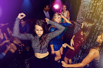 Image showing Nightclub, dancing and women at party to celebrate birthday, happy hour or new years group energy and happiness on dance floor. Group, crowd and ladies night at club event with music and happy people