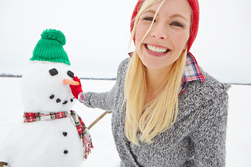 Image showing Portrait, snow and woman building a snowman from Sweden in winter happy about holiday. Female face with happiness and christmas excitement on vacation outdoor for holidays travel in nature