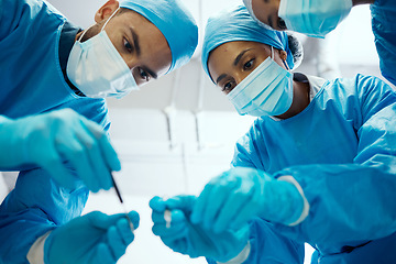 Image showing Surgery, teamwork or doctors in a medical emergency operation theater with collaboration or team work helping a patient. Support, life insurance or focused healthcare workers in face masks working