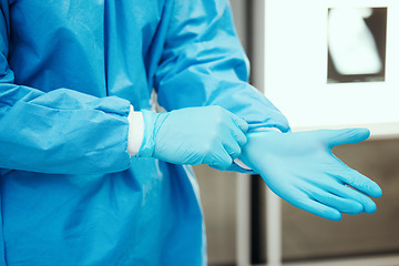 Image showing Healthcare, scrubs and surgeon hands with gloves for protection in surgery, medical operation and procedure. Safety, doctor and health worker with latex ppe in clinic, hospital and operating room