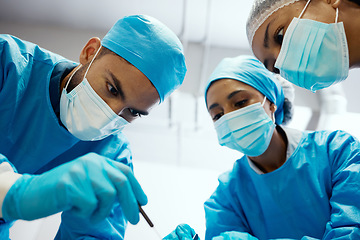 Image showing Surgery, team and hospital with surgeon support from medical staff in an operating room. Operation, collaboration and healthcare or doctor teamwork in emergency procedure while wearing scrubs