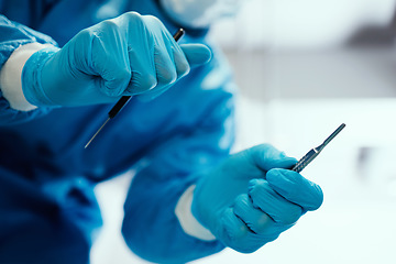 Image showing Healthcare, surgeon and hands with a scalpel for procedure in an operating room at hospital. Closeup of doctor or nurse with medical equipment for surgery in emergency room at medicare clinic center.