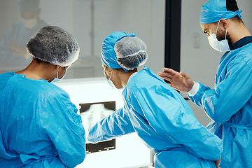 Image showing Surgery, xray and medical team analyze image before an operation in a healthcare facility. X ray, surgical staff and collaboration in an operating theater while reviewing the human anatomy