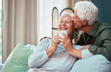 Image showing Kiss, coffee and senior couple laughing, talking and smile during retirement in the living room of their house. Relax, love and elderly man and woman with affection, tea drink and comic conversation