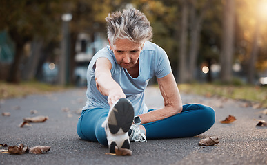 Image showing Senior woman runner, street and stretching for healthy exercise, urban workout and outdoor training. Elderly lady, metro park and warm up for running, health or balance on road for wellness in Aurora