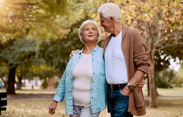 Image showing Senior couple, bonding or walking in nature park, city garden or public environment in relax exercise, mobility or retirement break. Smile, happy woman or talking elderly man in hug and weekend date