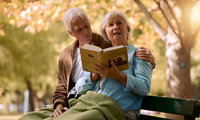 Image showing Senior couple, reading book and relax outdoor on bench in summer for retirement freedom, travel adventure and happy together in New York park. Love, elderly man and calm woman on park bench with book