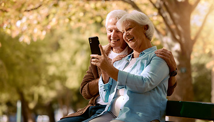 Image showing Senior couple, selfie and smile in park, happy and trees by blurred background for social media. Elderly man, old woman and smartphone on park bench for happiness photo, love or video call in Quebec