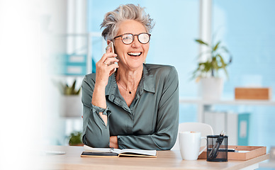 Image showing Phone call, communication and laughing with a senior woman sitting in her office, working alone and networking. Contact, mobile and business with a mature female employee joking while speaking