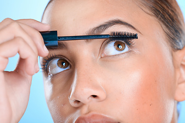 Image showing Makeup, eyelashes and woman with mascara brush, beauty and skincare against blue studio background. Cosmetics, Latino female or girl confident, volume and relax for face, luxury and wellness for eyes