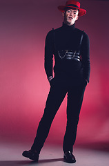 Image showing Fashion, vitiligo and leather with a black man model in studio on a red background for trendy or unique style. Portrait, creative and edgy with a young male posing to promote and clothes brand