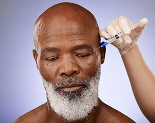 Image showing Hand, face and botox with a senior black man getting a syringe injection in studio on a purple background. Plastic surgery, anti aging and treatment with a mature male in a salon for a facelift