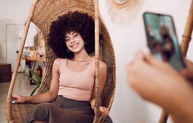 Image showing Black woman, smile and swing chair with a phone for a photograph for social media, blog or online marketing or advertising. Face of influencer happy while posing for profile picture as network user
