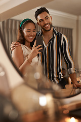 Image showing Dinner party, celebration and couple with selfie on a phone in mirror enjoy holiday, festival and Christmas party. Social event, restaurant and young happy man and woman take picture with smartphone