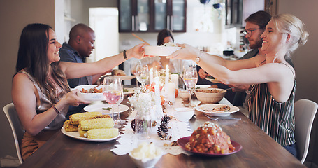 Image showing Christmas, celebration and friends eating lunch, hosting and happy with food at dining room table as a group. Party, social and men and woman with a festive dinner during Thanksgiving holiday