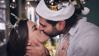 Image showing Party, love and couple kiss at christmas house celebration for bonding, care and appreciation. Marriage, partner and holiday of young people kissing at festive event in home together.