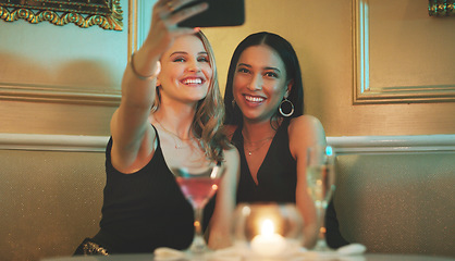 Image showing Girl friends, phone and selfie at a nightclub for cocktail celebration with happy women and alcohol. Mobile photo, smile and restaurant drinks of people at a event for new year or happy hour