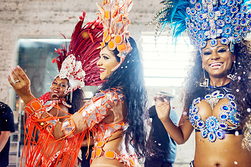 Image showing Women, dancing and carnival fashion in Brazilian party event, festive celebration or New Year salsa performance. Smile, happy friends and samba dancers and feather accessory or festival show clothes