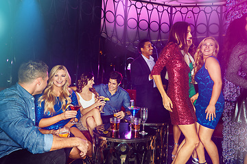 Image showing Party, women and dancing at a nightclub with cocktail drinks, friends and lighting to celebrate new years, birthday or happy hour. Men and women people together for celebration at club or event