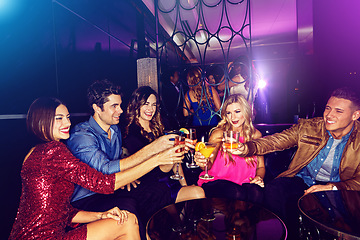 Image showing Party, toast and new year with friends in a club, drinking during a celebration event together. Birthday, crowd and cheers with a man and woman friend group enjoying a drink while bonding in a club