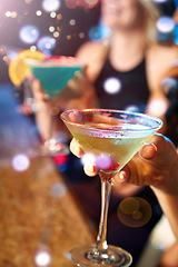 Image showing Hand, cocktail and nightclub with a woman at a bar for drinking, fun or new year celebration closeup. Party, birthday and glass with a female enjoying a drink while clubbing for weekend nightlife