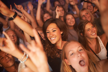 Image showing Fans, audience and people at concert, music festival and band performance with happy energy while dancing at celebration for new years. Women crowd excited and crazy at event for live show at club