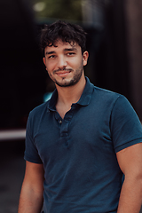 Image showing A portrait of a modern man, exuding confidence and style, against an outdoor backdrop, showcasing his charisma and fashionable demeanor.